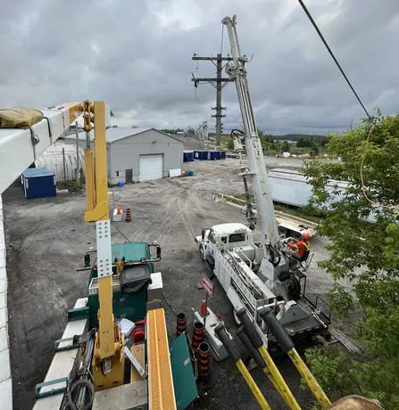 A crane is being used to lift a power line.