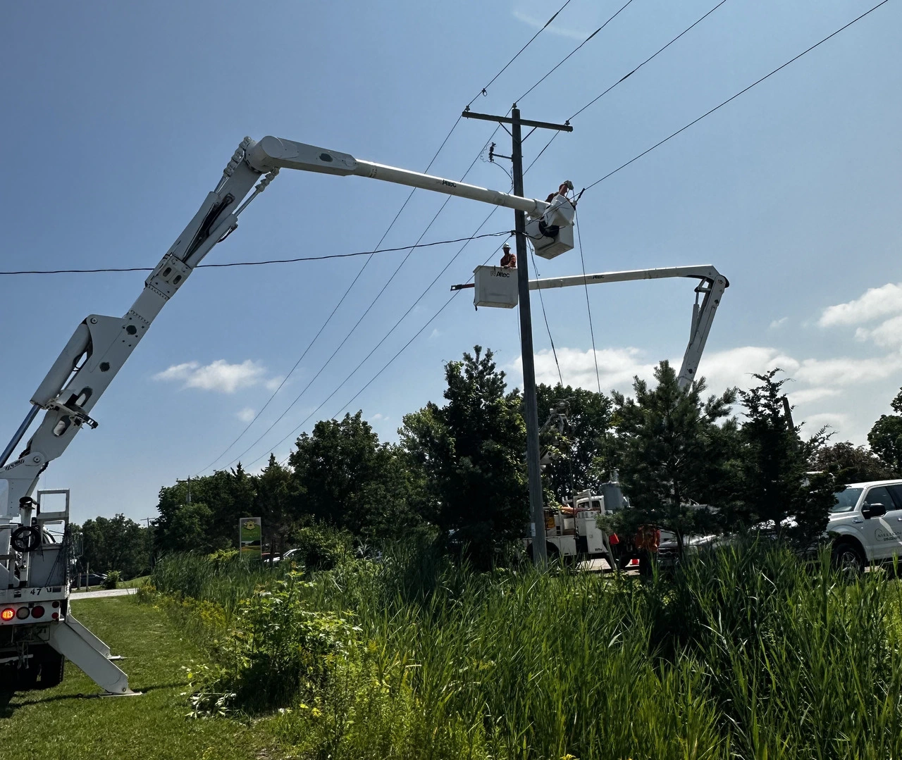 A group of people working on power lines.