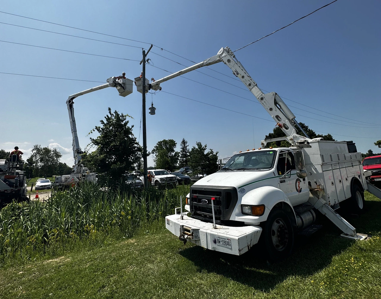 A white truck is parked in the grass