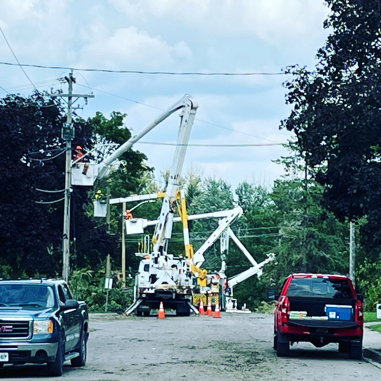 A street scene with cars and power lines.