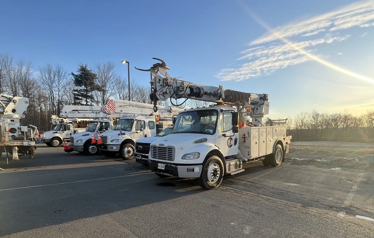 A group of trucks parked in a parking lot.