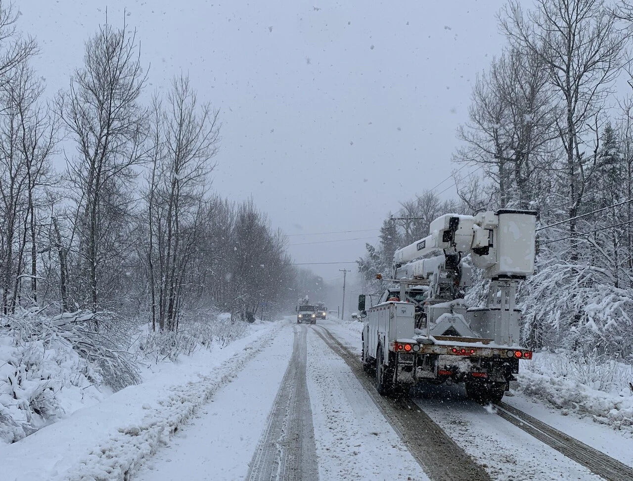 A truck driving down the road in snow.