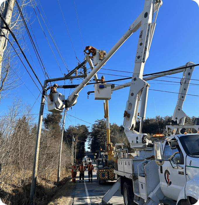 A group of men working on power lines.