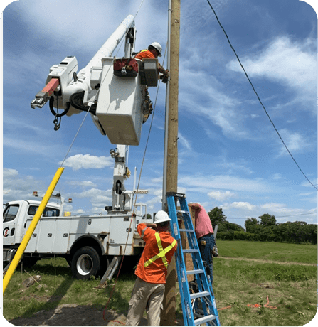 A group of men working on power lines.